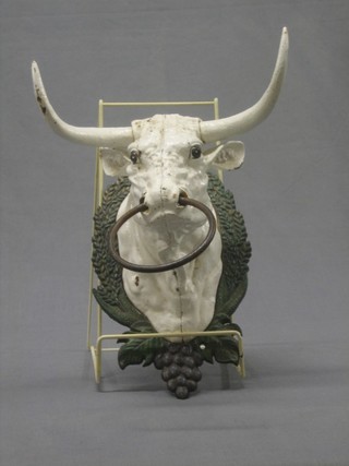 A decorative iron towel holder in the form of a bulls head