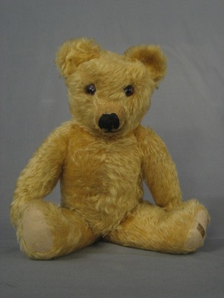 A Merrythought yellow mohair teddy bear with stitched nose and articulated limbs, label to foot 18"
