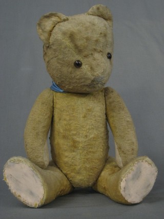 A yellow teddy bear with articulated limbs