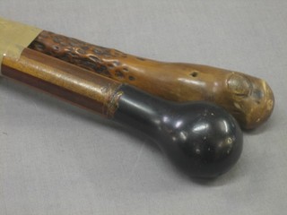 An Eastern walking cane and 1 other