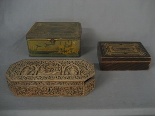 An Eastern carved lozenge shaped box with hinged lid, a painted box with hinged lid and a Bluebird toffee tin