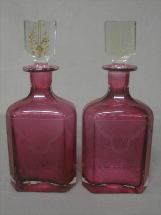 A pair of red cut glass decanters and stoppers 7"