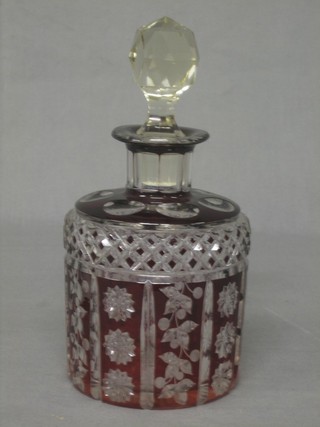 A cylindrical red overlay cut glass decanter and stopper 6"