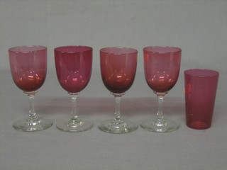 A cranberry glass beaker and 4 various cranberry glass glasses with clear glass stems 