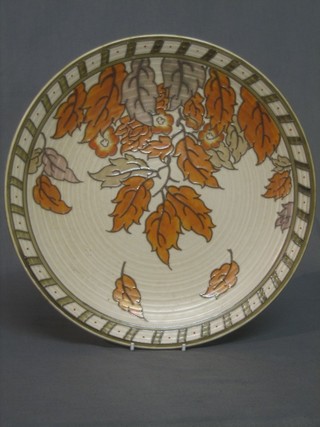 A circular Crown Ducal Charlotte Rhead charger with leaf decoration, the base marked Crown Ducal Rhead 4921 12"