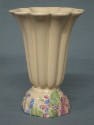 A pink glazed Clarice Cliff Newport Pottery trumpet shaped vase, the base with floral encrusted decoration 7"
