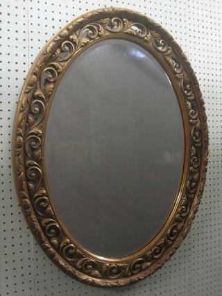 A bevelled plate wall mirror contained in a decorative gilt frame 29"