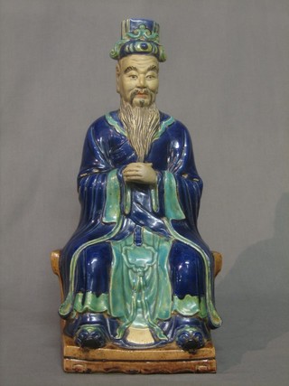 An Oriental porcelain figure of a seated Deity 16"