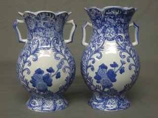 A pair of 19th Century blue and white twin handled vases with floral decoration 9"