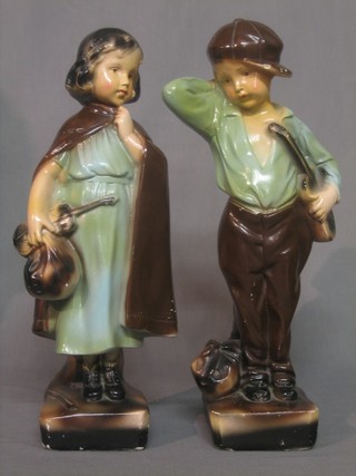 A pair of 1930's plaster figures in the form of a boy and girl (boy f and r) 17"