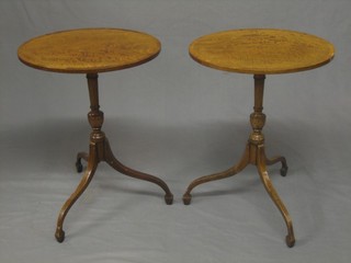 A pair of oval 19th Century satinwood wine tables, raised on pillar and tripod supports 16"