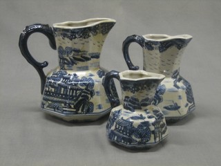 A set of 3 graduated 19th Century style blue and white octagonal pottery jugs
