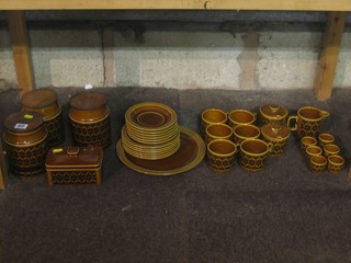 A Hornsea Heirloom pattern brown glazed tea set comprising 6 cups and saucers (1 cup cracked), cream jug, jam pot, sugar bowl, 3 storage jars, butter dish and cover, plates and 6 egg cups