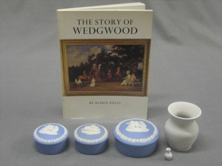 1 volume "The Story of Wedgwood", a pair of circular blue Jasperware jars and covers 2 1/2" and 1 other 3" and a white glazed vase 3"