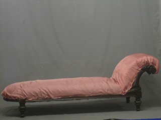 A 19th Century carved mahogany show frame chaise longue, upholstered in pink material 77"