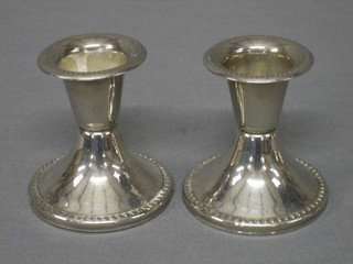 A pair of silver plated stub shaped candlesticks with beadwork borders 2"