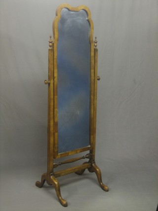 A Queen Anne style shaped plate cheval mirror contained in a walnut swing frame