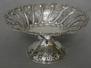 A pierced circular silver dish raised on a spreading foot, Sheffield 1912, 9 ozs