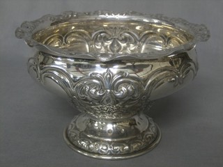 An Edwardian circular embossed silver bowl, raised on a spreading foot, Sheffield 1901, 15ozs