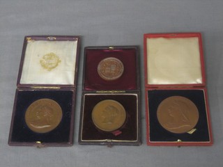 A Victorian bronze 1895 International Inventions Exhibition medallion together with 3 other Victorian bronze medallions