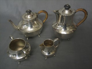 An engraved silver plated 4 piece tea service comprising teapot, hotwater jug, twin handled sugar bowl and cream jug