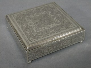 An Eastern engraved silver box with hinged lid, raised on 4 bun feet 8 ozs