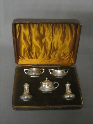 A silver 5 piece condiment set comprising 2 twin handled salts, mustard pot and 2 pepper pots, complete with blue glass liners,5 ozs,  Birmingham 1923/24, cased