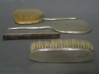 A 4 piece silver backed dressing table set comprising hair brush, hand mirror, clothes brush and comb, Birmingham 1965