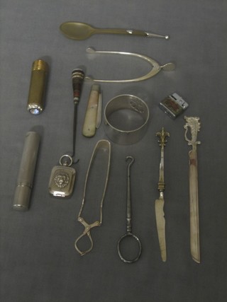 A Sterling silver cased lighter, a silver bladed fruit knife with mother of pearl grip, a pair of silver wishbone sugar tongs (f) and other curios etc