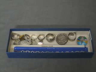 A shallow box containing a collection of mostly silver and enamelled costume jewellery