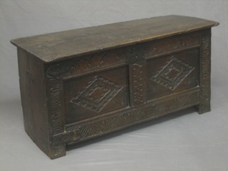 A 17th/18th Century oak coffer of panelled construction with hinged lid, (lid with old repairs) the interior fitted a candle box, 35"