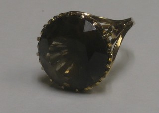 A 9ct gold dress ring set a circular smoky quartz
