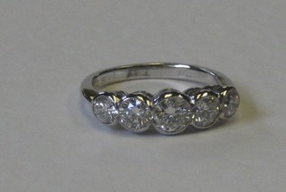 A lady's 18ct white gold dress/engagement ring set 5 graduated diamonds