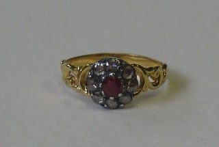 A lady's 18ct yellow gold dress ring set rubies surrounded by diamonds