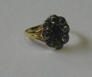 A lady's 18ct gold dress ring set an amethyst surrounded by diamonds
