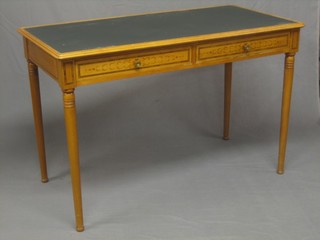 A satinwood writing table with inset tooled writing surface above 2 long drawers, raised on turned supports 47"