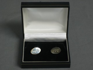 A pair of engraved silver cufflinks, cased