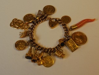 A gold curb link charm bracelet hung a Victorian 1887 half sovereign and 14 other charms