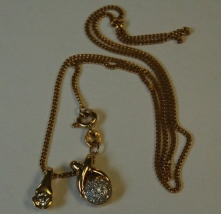 A modern gold curb link chain hung 2 18ct gold pendants set diamonds