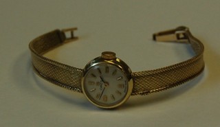 A lady's Omega wristwatch contained in a 14ct gold case with integral gold bracelet