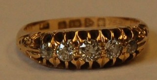 An 18ct gold dress ring set 5 graduated diamonds