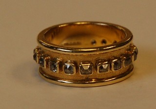 An 18ct gold dress ring set numerous diamonds