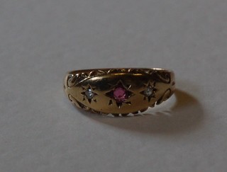 A lady's gold dress ring set a ruby and diamonds