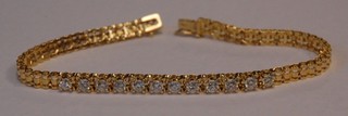 An 18ct gold bracelet set 12 diamonds approx. 1ct