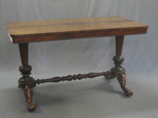 A Victorian rosewood library table, raised on turned supports with turned framed stretcher 50"