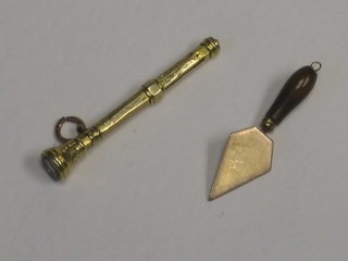 A miniature gilt cased propelling pencil and a miniature gilt metal trowel with hardstone handle