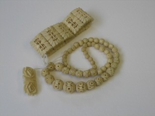 A pierced carved ivory bracelet, a necklace and a brooch