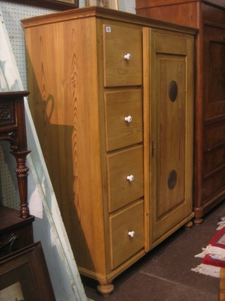 A Continental stripped and polished pine cupboard flanked by 4 long drawers raised on bun feet 42"