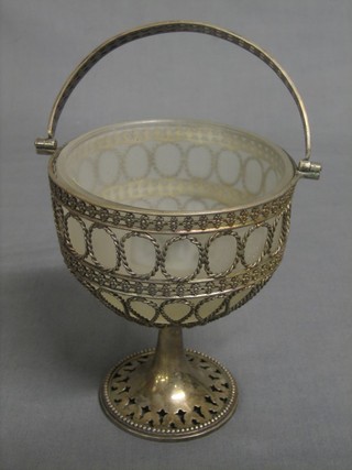 A pierced silver plated sugar bowl with white glass liner, raised on a spreading foot