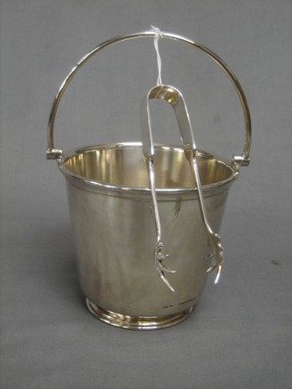 A silver plated ice pail and a pair of ice tongs 